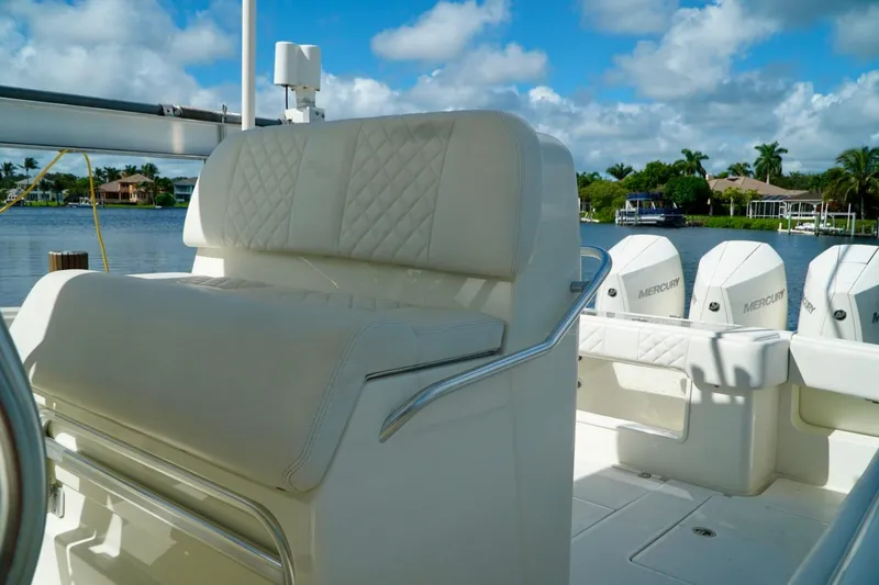  Yacht Photos Pics 2017 SeaVee 34Z boat interior with luxurious seating and Mercury engines, docked by a scenic waterfront.