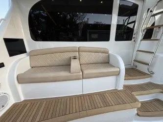 Slabjack Yacht Photos Pics 2017 Viking 55 Convertible yacht with beige seating and teak flooring.