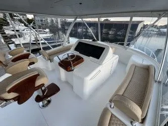 Slabjack Yacht Photos Pics 2017 Viking 55 Convertible yacht interior with helm, seating, and marina view.