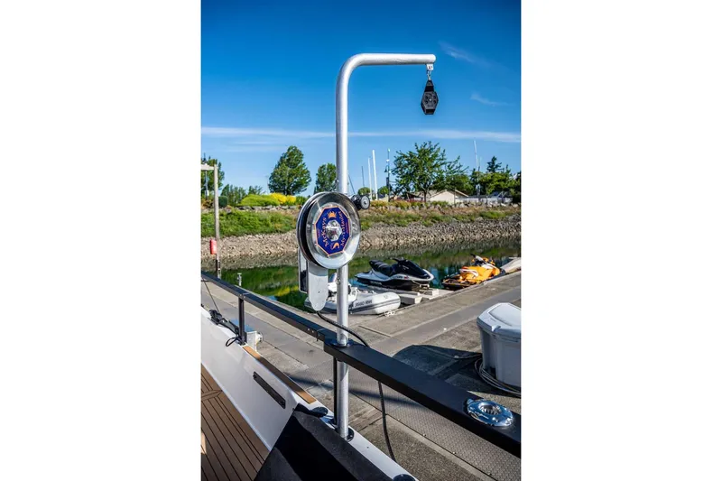  Yacht Photos Pics 2025 Targa 46 yacht deck with winch system, docked near jet skis, sunny day.