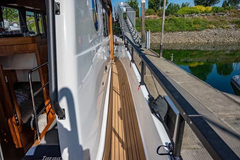  Yacht Photos Pics 2025 Targa 46 boat docked, showcasing sleek design and wooden deck details.