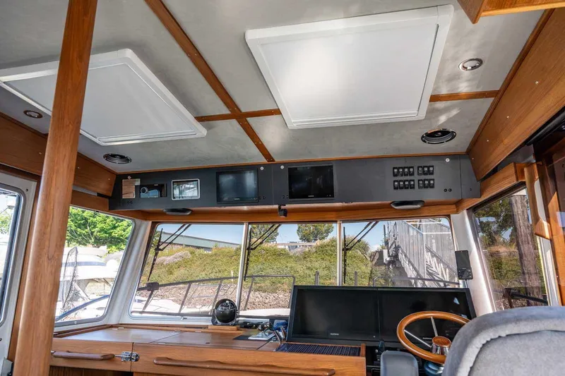 Yacht Photos Pics Interior of 2025 Targa 46 boat cockpit with modern navigation equipment and wooden accents.