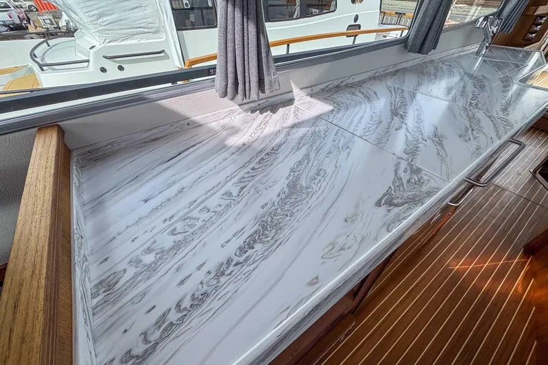  Yacht Photos Pics Luxurious marble countertop in 2025 Targa 46 yacht interior, featuring elegant wood accents.