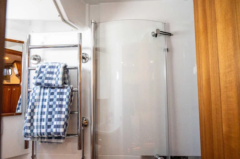  Yacht Photos Pics Modern bathroom in 2025 Targa 46 yacht with glass shower and towel rack.