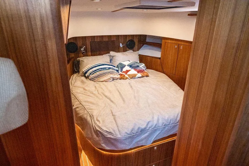  Yacht Photos Pics Cozy cabin interior of 2025 Targa 46 yacht with wooden finish and comfortable bedding.