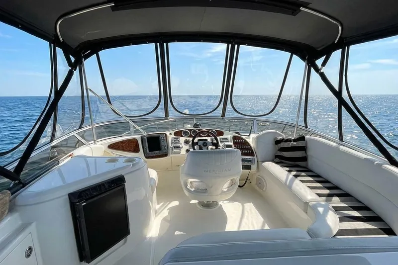 Jamm Yacht Photos Pics 2005 Meridian 459 Motoryacht helm with ocean view, featuring luxurious seating and navigation controls.