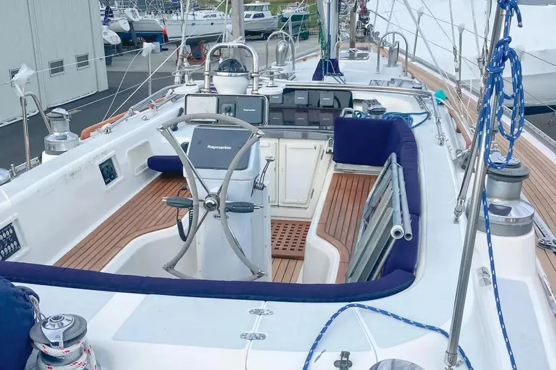 Violina Yacht Photos Pics Cockpit of a 1999 Hylas 54 sailboat with wooden deck and navigation equipment.