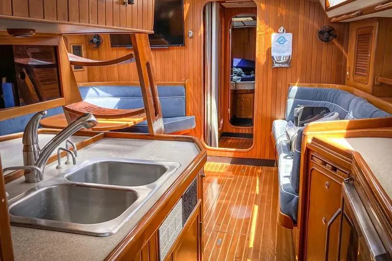 Violina Yacht Photos Pics Luxurious 1999 Hylas 54 yacht interior with wood finish and modern amenities.