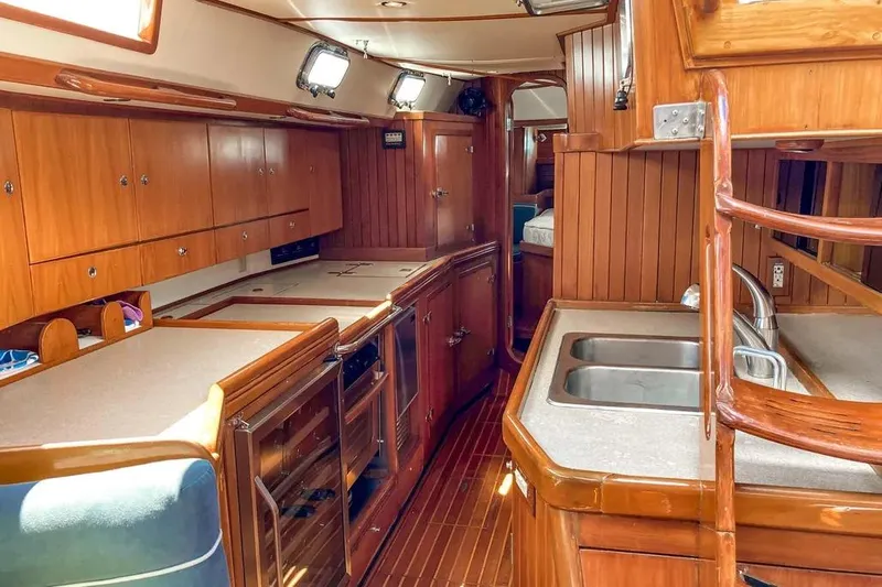 Violina Yacht Photos Pics Interior of 1999 Hylas 54 yacht with wooden cabinetry and dual sinks.