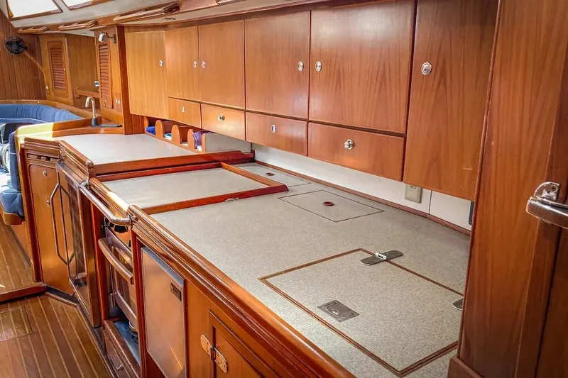 Violina Yacht Photos Pics Interior of a 1999 Hylas 54 yacht with wooden cabinetry and countertops.