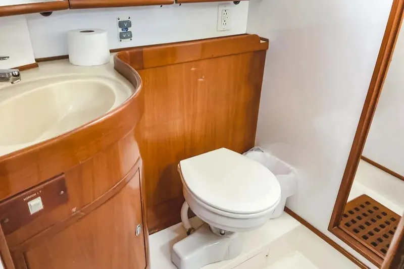 Violina Yacht Photos Pics Luxurious bathroom in 1999 Hylas 54 yacht with wooden cabinetry and modern fixtures.