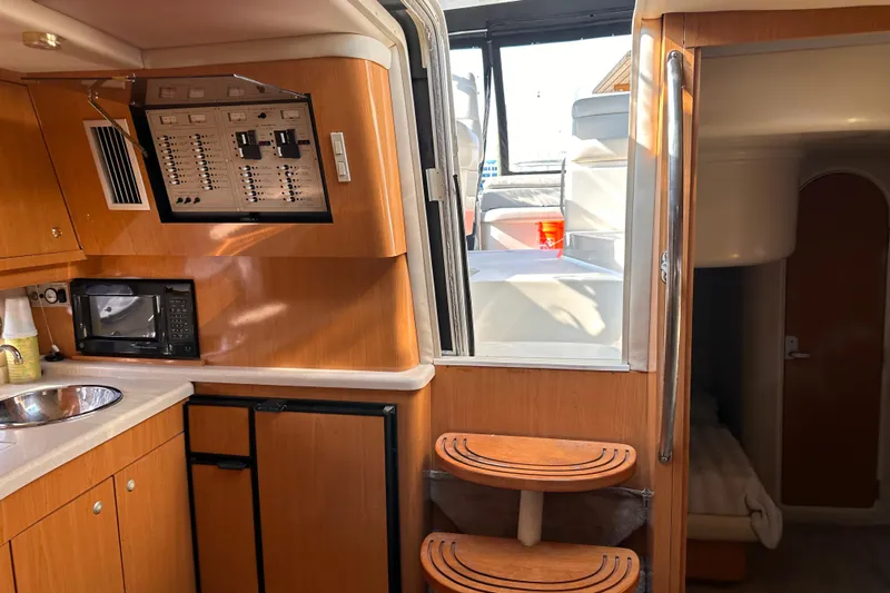  Yacht Photos Pics Interior of 2001 Regal Commodore 4160 yacht with kitchenette and cabin access.