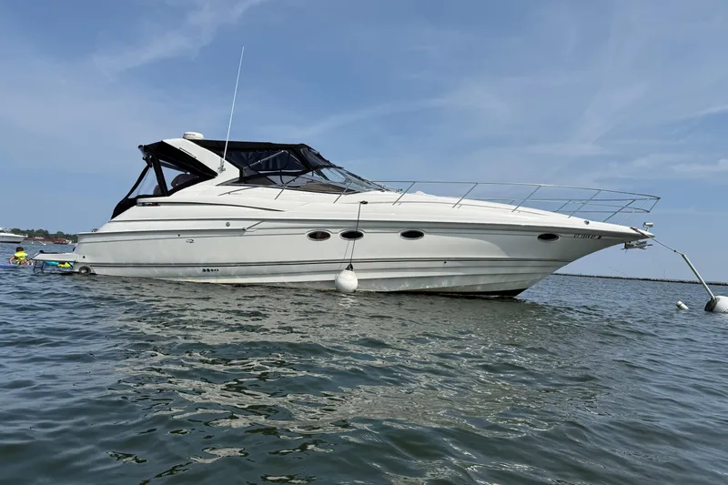  Yacht Photos Pics 2001 Regal Commodore 4160 yacht anchored on calm water under a clear blue sky.