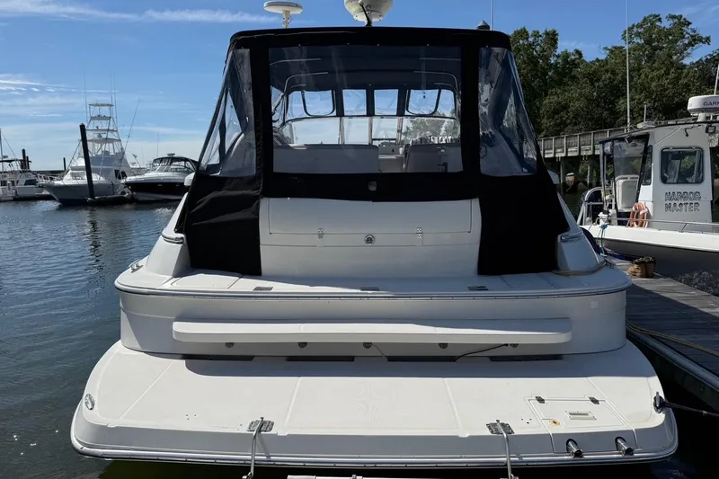  Yacht Photos Pics 2001 Regal Commodore 4160 yacht docked at marina, rear view with black canopy.