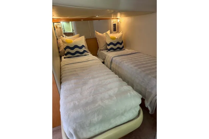  Yacht Photos Pics Twin beds in a 2001 Regal Commodore 4160 yacht cabin, featuring cozy bedding and decorative pillows.