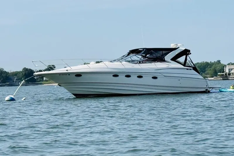  Yacht Photos Pics 2001 Regal Commodore 4160 yacht anchored on calm water, scenic background.
