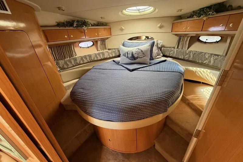  Yacht Photos Pics Luxurious cabin interior of 2001 Regal Commodore 4160 yacht with cozy bed and elegant decor.