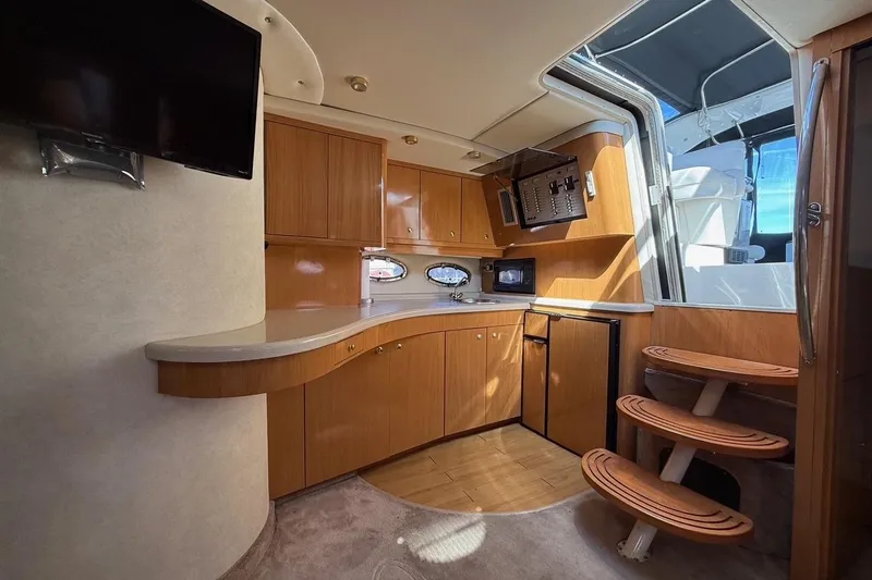  Yacht Photos Pics Interior of 2001 Regal Commodore 4160 yacht with wooden cabinetry and modern amenities.