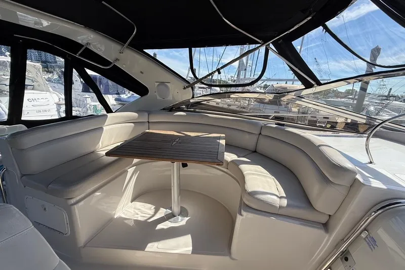  Yacht Photos Pics Luxurious seating area on a 2001 Regal Commodore 4160 yacht with a wooden table.