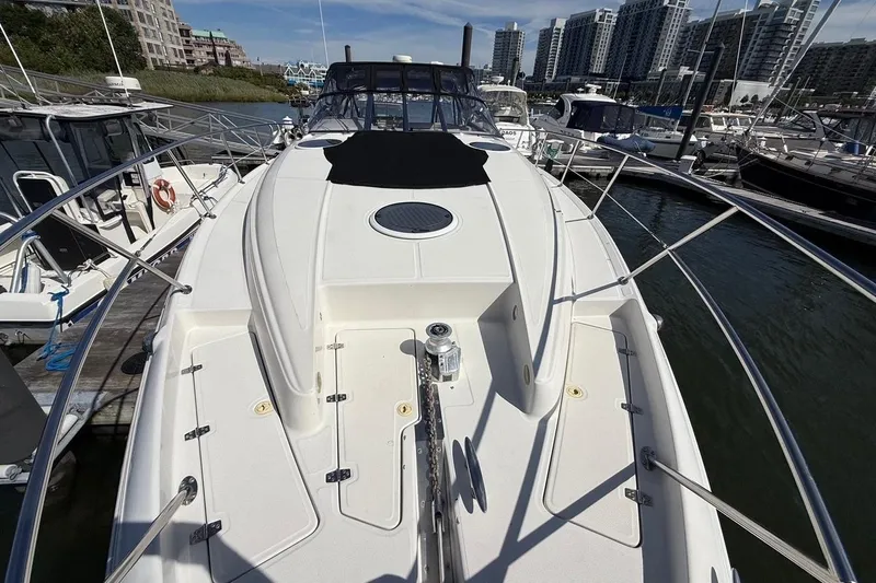  Yacht Photos Pics 2001 Regal Commodore 4160 yacht docked in marina, surrounded by modern buildings.
