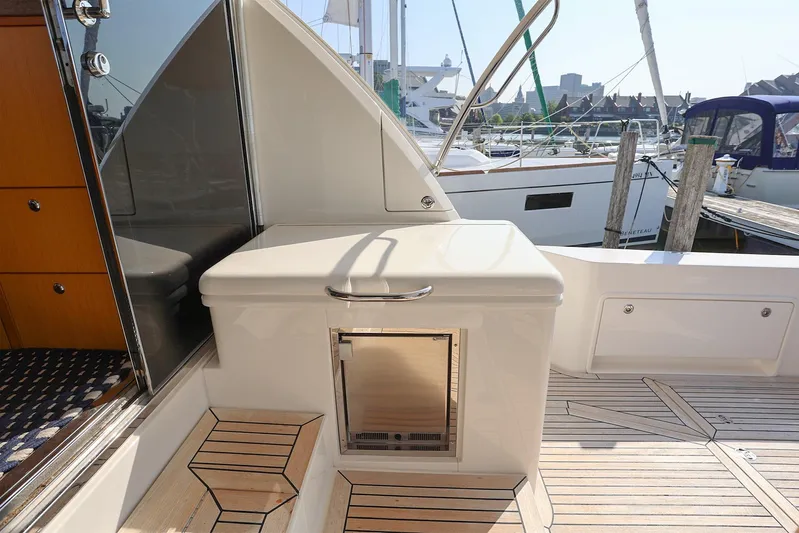  Yacht Photos Pics 2016 Riviera 525 SUV yacht deck with sleek design and wooden flooring.