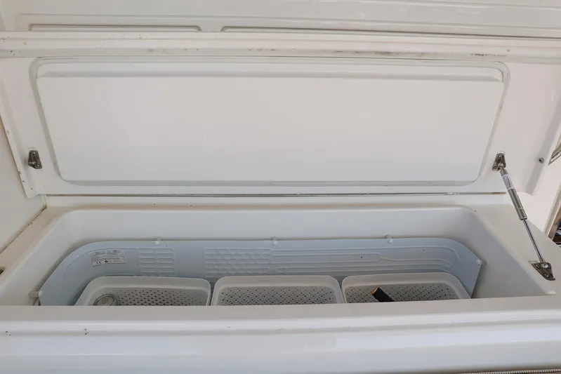  Yacht Photos Pics Open storage compartment in 2016 Riviera 525 SUV boat.