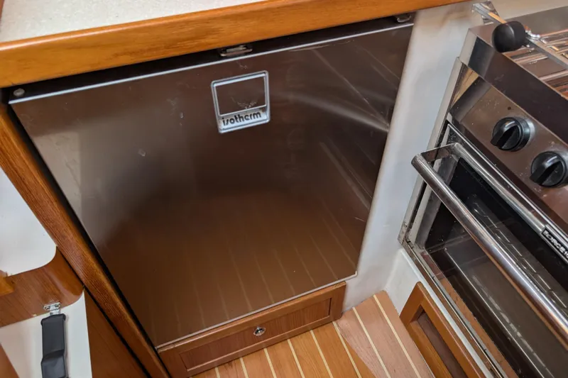 Uno Mas Yacht Photos Pics 2021 Catalina 315 yacht kitchen with Isotherm fridge and stove.