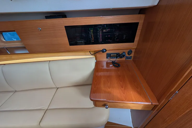Uno Mas Yacht Photos Pics 2021 Catalina 315 yacht interior with navigation station and beige seating.