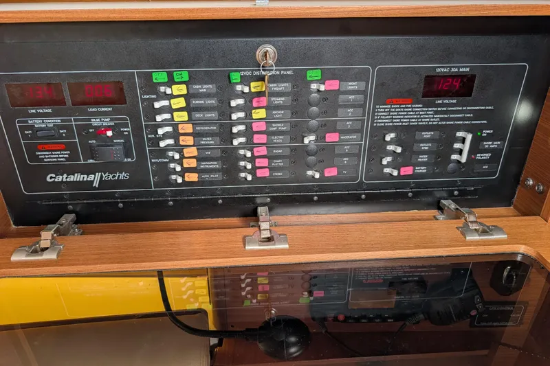 Uno Mas Yacht Photos Pics Control panel of a 2021 Catalina 315 yacht with various switches and indicators.