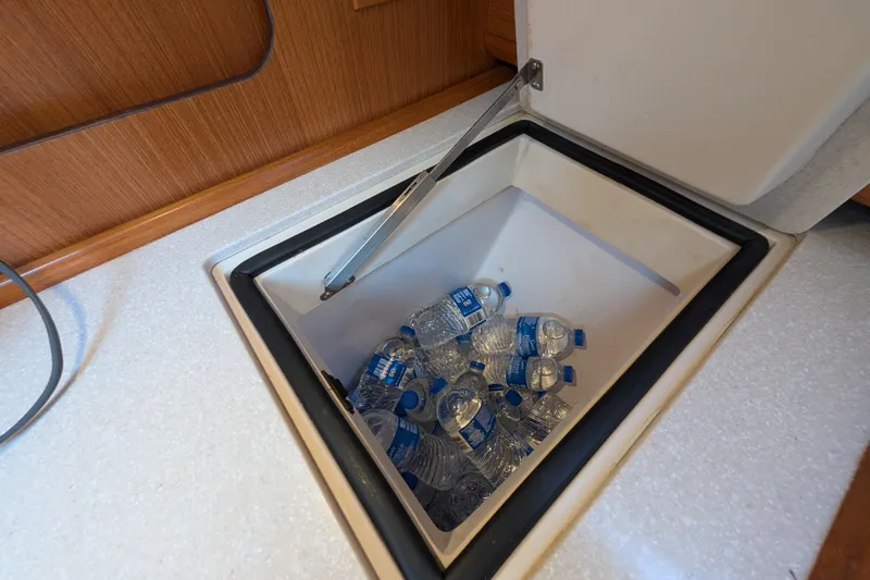 Uno Mas Yacht Photos Pics Built-in cooler with water bottles on a 2021 Catalina 315 sailboat.