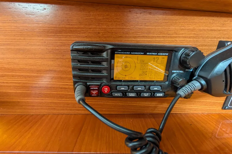 Uno Mas Yacht Photos Pics VHF radio on 2021 Catalina 315 sailboat, displaying GPS coordinates and settings.