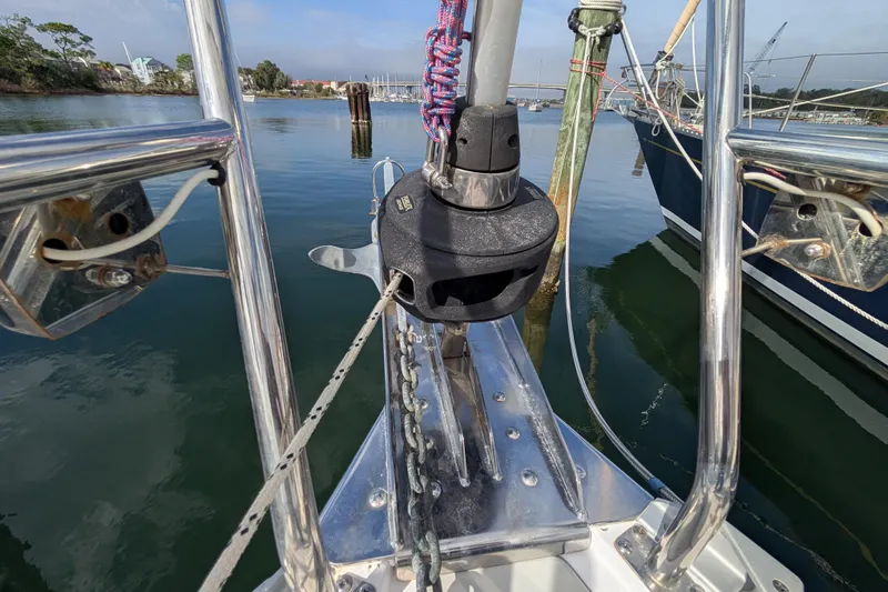 Uno Mas Yacht Photos Pics Bow of 2021 Catalina 315 sailboat with anchor and calm marina view.