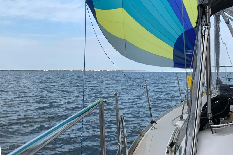 Uno Mas Yacht Photos Pics Sailing on a 2021 Catalina 315 with colorful spinnaker over open water.