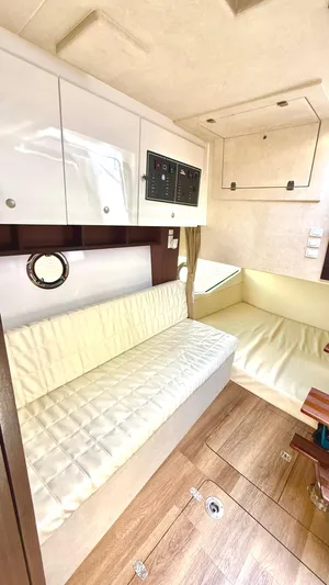  Yacht Photos Pics Interior of 2022 Evolve 400HT boat with white seating and wood flooring.