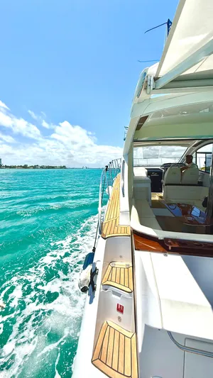  Yacht Photos Pics Luxury Evolve 400HT yacht cruising on turquoise waters under a clear blue sky.