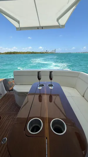  Yacht Photos Pics Luxury Evolve 400HT yacht, 2022 model, cruising on turquoise waters with elegant seating and table.