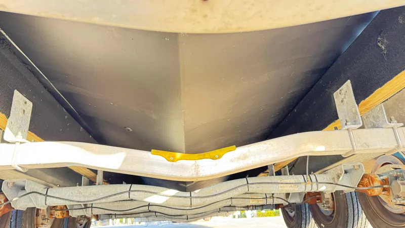  Yacht Photos Pics Underside view of 2022 Evolve 400HT boat on trailer, showcasing hull and suspension.