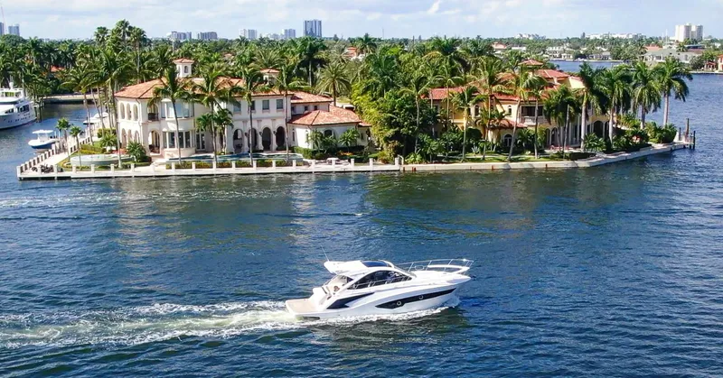  Yacht Photos Pics Evolve 400HT yacht cruising near luxurious waterfront estate, 2022 model.