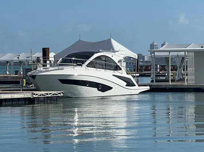  Yacht Photos Pics Luxury Evolve 400HT yacht docked at marina, 2022 model, calm waters, clear sky.