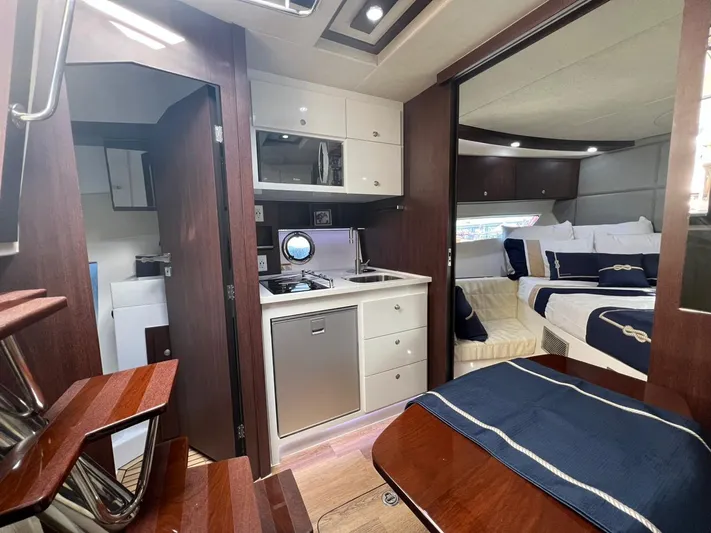  Yacht Photos Pics Luxurious interior of 2022 Evolve 400HT yacht with kitchen and cozy sleeping area.