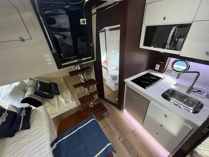  Yacht Photos Pics Interior of 2022 Evolve 400HT yacht with modern kitchen, bed, and stairs.