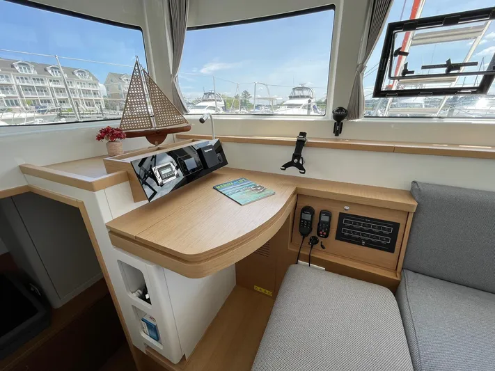 Artemis Yacht Photos Pics Interior of 2022 Excess 12 yacht with navigation station and model sailboat.