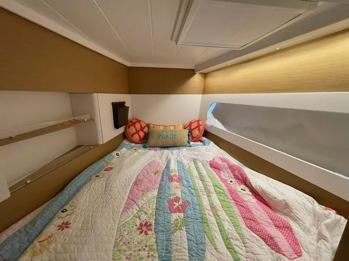 Artemis Yacht Photos Pics Cozy cabin interior of 2022 Excess 12 with colorful bedding and decorative pillows.