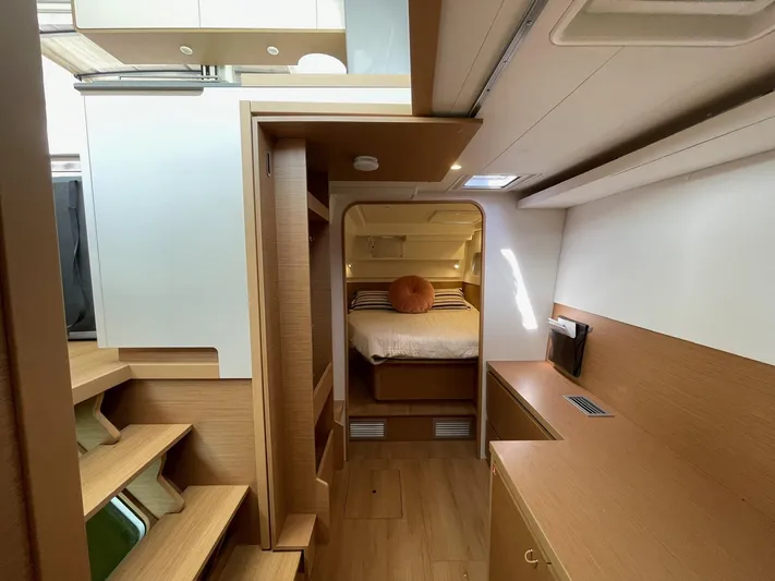 Artemis Yacht Photos Pics Modern interior of 2022 Excess 12 yacht with wooden finishes and cozy sleeping area.