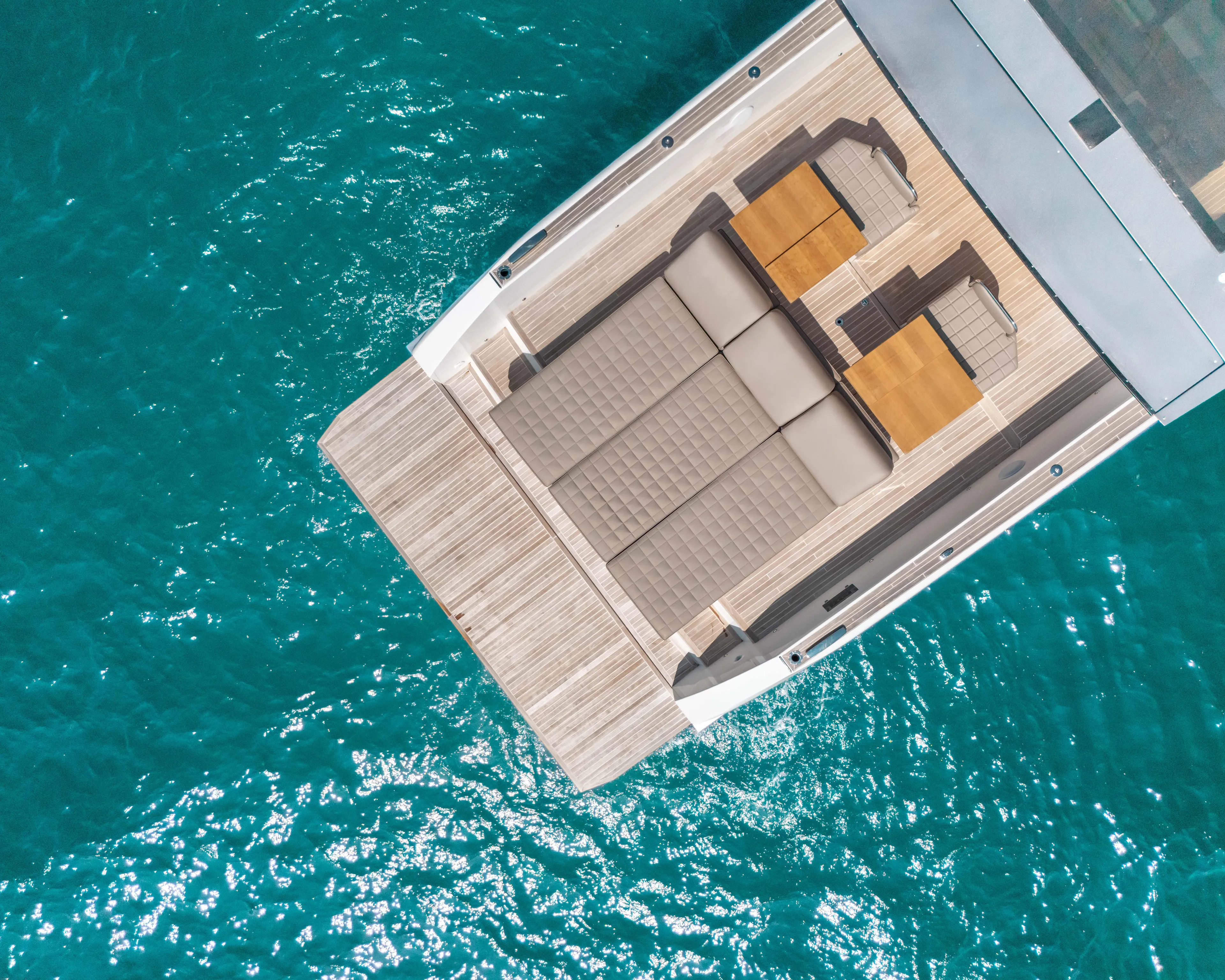  Yacht Photos Pics Aerial view of 2023 Fiart SEAWALKER 43 yacht deck on turquoise water.