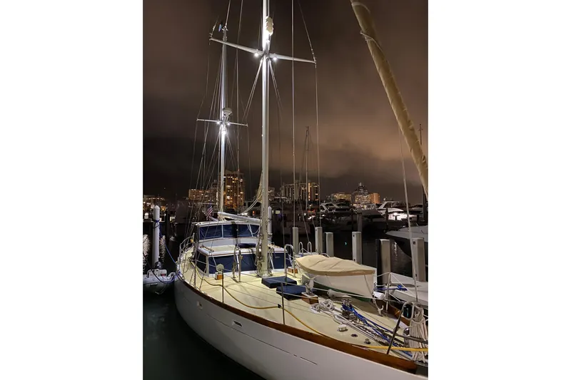 Scout (name Reserved) Yacht Photos Pics 1971 Alden Boothbay Explorer yacht docked at night with city skyline.