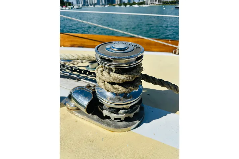 Scout (name Reserved) Yacht Photos Pics Winch on 1971 Alden Boothbay Explorer sailboat with rope, docked near cityscape.