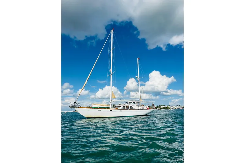 Scout (name Reserved) Yacht Photos Pics Sailboat Alden Boothbay Explorer 1971 on blue ocean under cloudy sky.