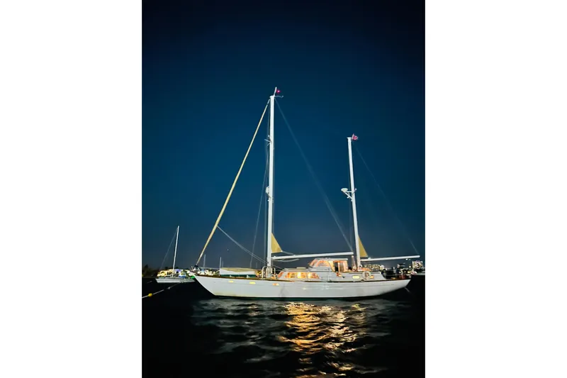 Scout (name Reserved) Yacht Photos Pics 1971 Alden Boothbay Explorer sailboat illuminated at night on calm waters.