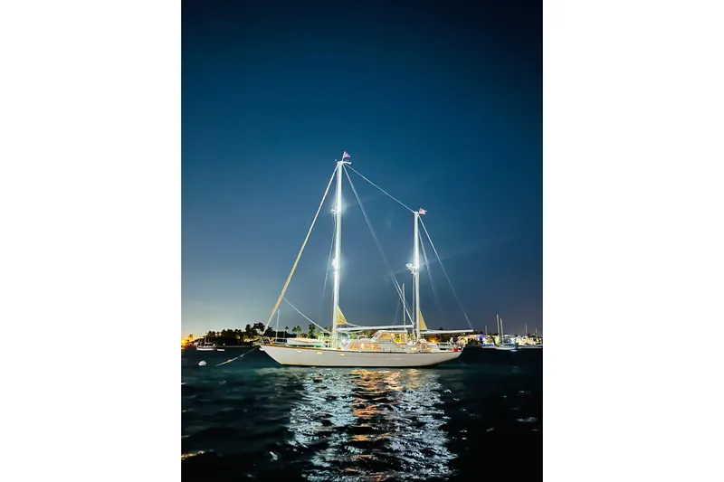 Scout (name Reserved) Yacht Photos Pics Sailboat Alden Boothbay Explorer 1971 illuminated at night on calm waters.